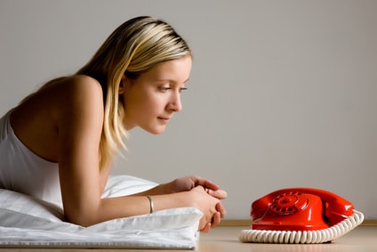 Teenager looking at red phone