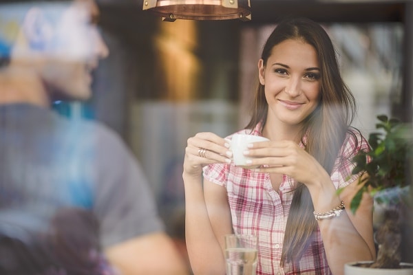 Young couple on first date drinking coffee