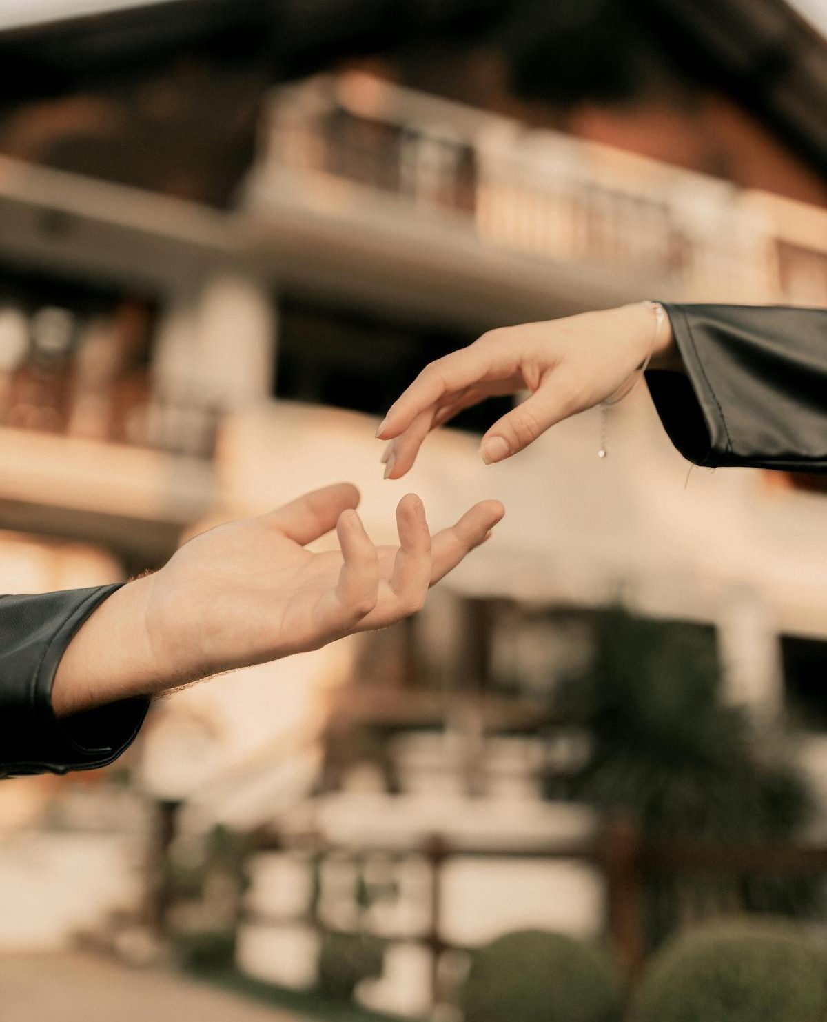 a female and a male hand reaching out to each other